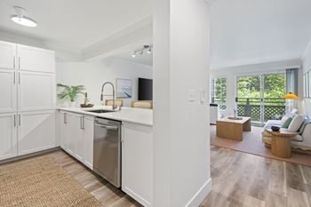 A modern kitchen with white cabinets and a stainless steel dishwasher. at Lakemont Orchard Apartments, Issaquah , WA, 98027